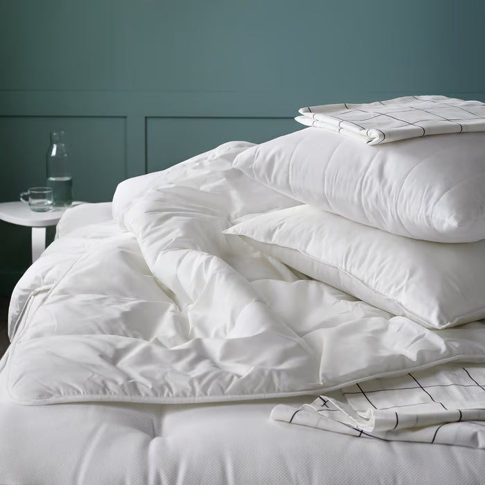IKEA SMÅSPORRE white duvet laid on a neatly made bed in a bedroom setting
