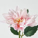 Close-up of IKEA SMYCKA artificial dahlia pink soft petals and green leaves showing realistic texture