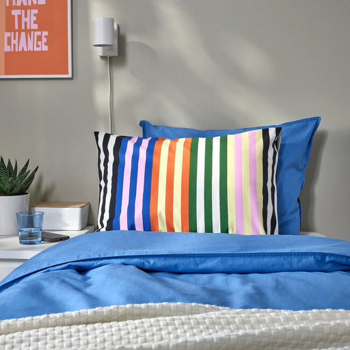 A Multicolour cotton pillowcase from IKEA lying on a bed adding a touch of elegance to the bedding