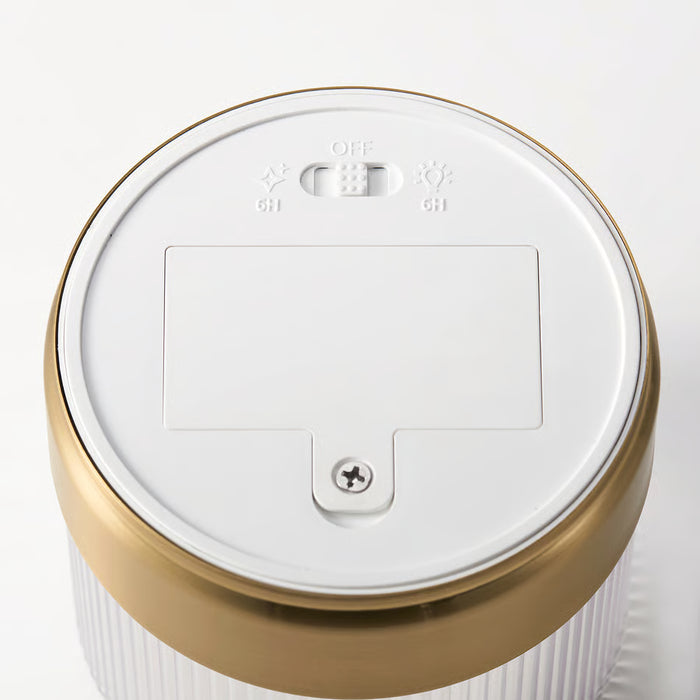 Close-up of IKEA SNÖRPTRÅD LED timer control panel showing 6-hour on/off and steady or flicker light modes
