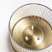 IKEA SNÖRPTRÅD brass ribbed bowl with three LED candles glowing on reflective surface