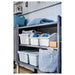 Grey storage rack with white SOCKERBIT bins, basket and folded blanket
