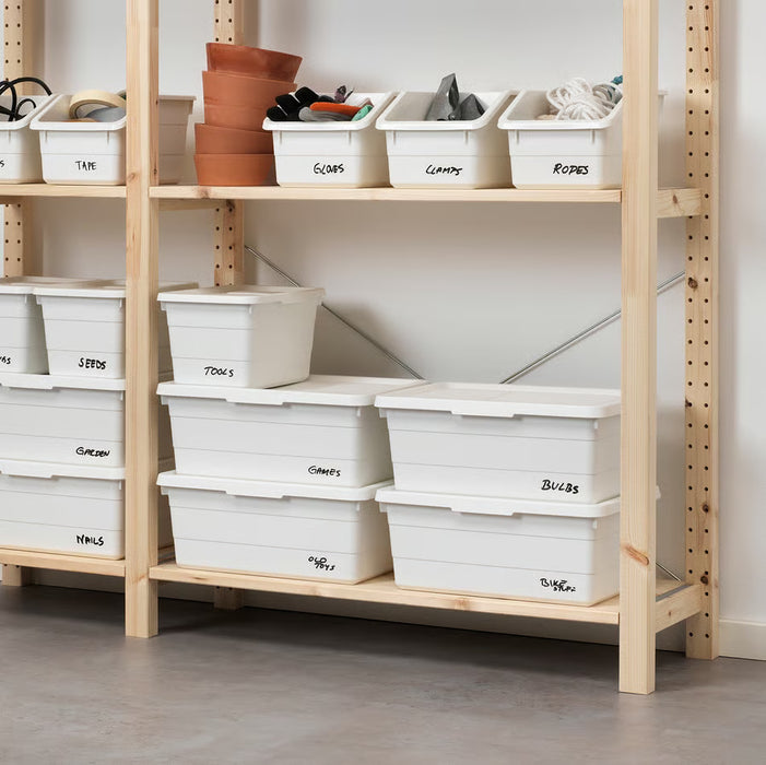 Wooden shelves with labelled SOCKERBIT boxes organising tools, seeds and games