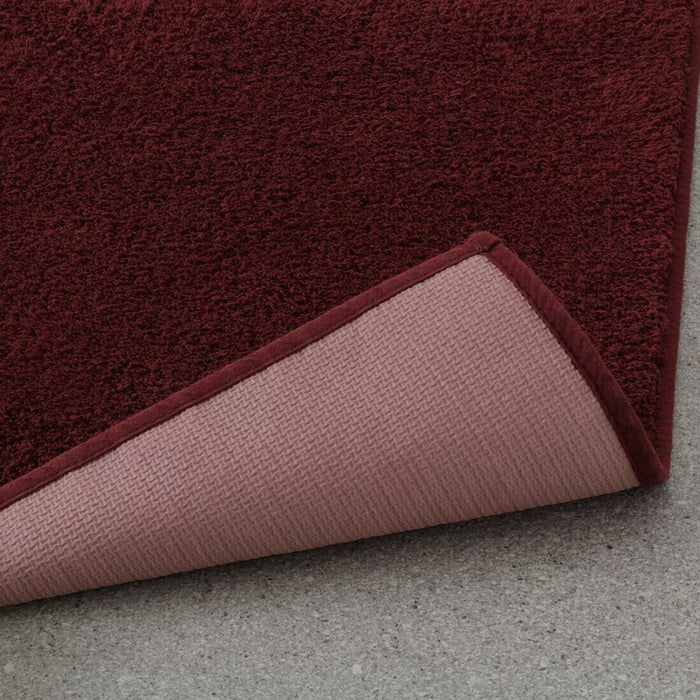 SÖDERSJÖN deep red bath mat, perfect for adding a pop of color to your bathroom