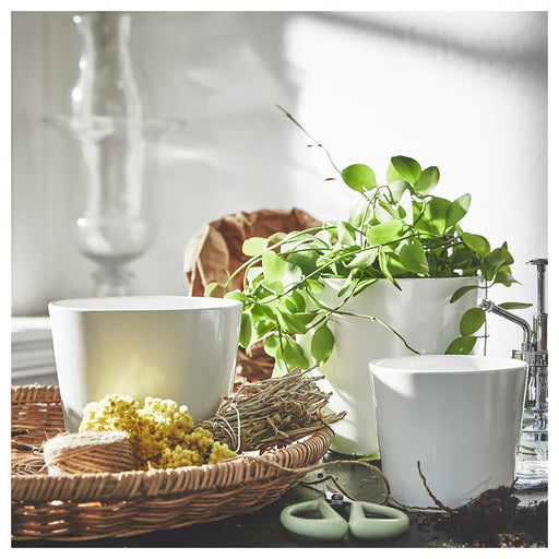  IKEA SOJABÖNA white plant pots on windowsill styled with green plants yellow flowers and gardening tools