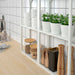 IKEA SOJABÖNA white and grey earthenware plant pots arranged on wooden shelves with lush green plants designed by Ilse Crawford