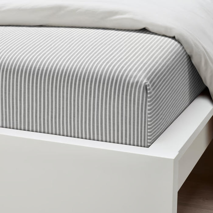 IKEA SOLFIBBLA grey stripe flat sheet on white bed showing cotton weave and stitching detail
