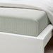 IKEA SOLFIBBLA green and white striped cotton flat sheet on a neatly made bed