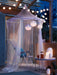 IKEA SOLIG net canopy set up over outdoor lounge area with pergola and table