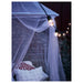 IKEA SOLIG net canopy over bed at night with warm string lights for a calm retreat
