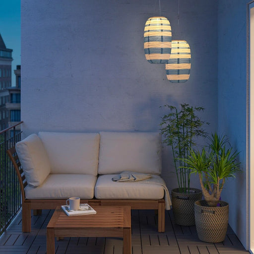 Sustainable IKEA SOLVINDEN solar-powered pendant lamp charging in sunlight, perfect for outdoor spaces.