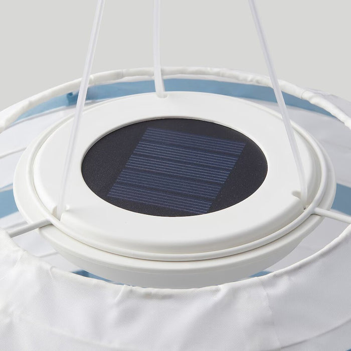 Close-up of IKEA SOLVINDEN solar-powered pendant lamp showcasing its blue stripe design and LED light.