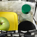 IKEA SPARTANSK clear glass water bottle with green lid placed next to an apple