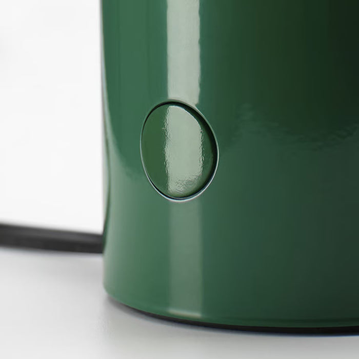 Close-up of IKEA SPETSBOJ green table lamp showing smooth glossy lines
IKEA SPETSBOJ green table lamp with sleek design showing side on/off button