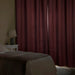 IKEA SPIRBJÖRNBÄR dark red curtains in bedroom blocking light beside white bedside lamp