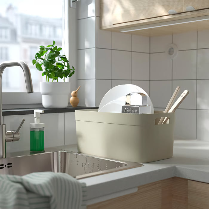  IKEA SPJUTLILJA dish drainer placed near kitchen sink with soap dispenser and green plant