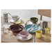 IKEA SPJUTLILJA yellow lid jars styled on wooden table with colourful kitchen accessories
