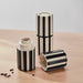 Hand grinding salt with IKEA SPJUTLILJA black and white striped spice mill over fresh salad