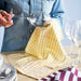 IKEA SPJUTLILJA tea towel on kitchen table with glass being poured, absorbent cotton fabric