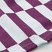 Close-up of IKEA SPJUTLILJA purple and white chequered cotton towel weave texture