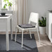 IKEA STAGGSTARR black white chair pad placed on white chair at home desk near window