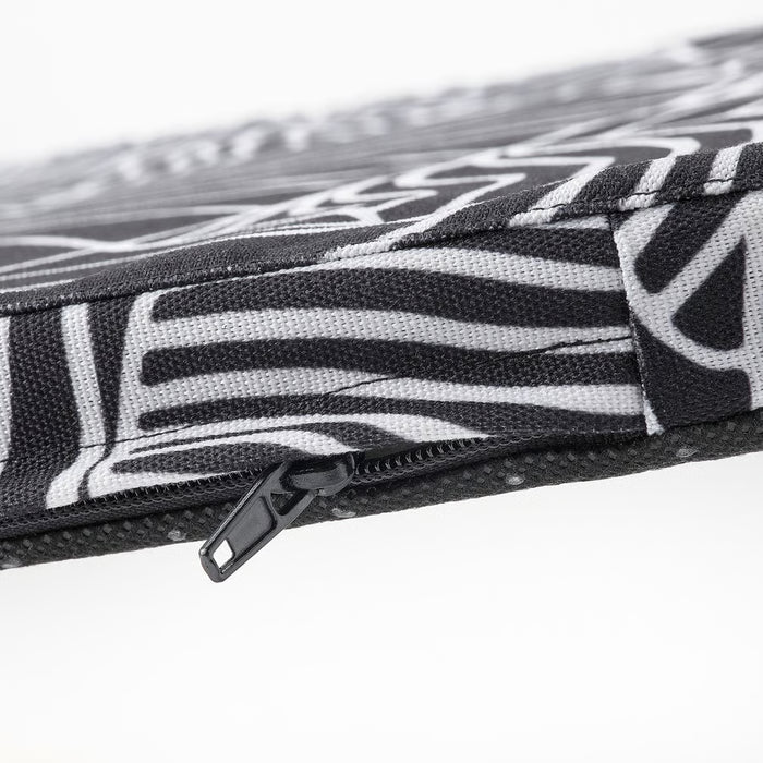 Close-up of IKEA STAGGSTARR black white chair pad showing zip stitching and patterned fabric detail