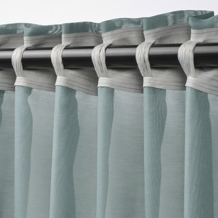 IKEA STENFRÖ sheer curtains partly drawn, light turquoise fabric diffusing daylight