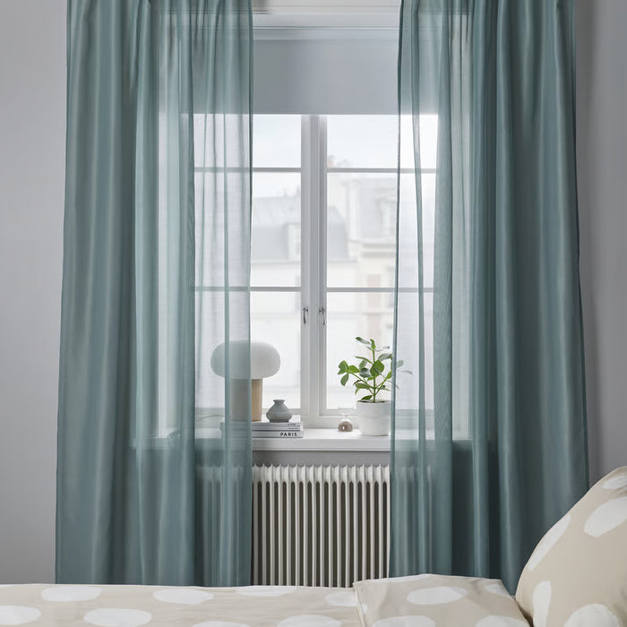 IKEA STENFRÖ turquoise sheer curtains in a room with natural daylight streaming through the sheer fabric