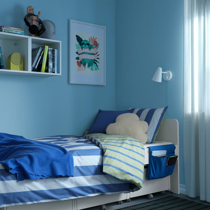 Kids bedroom with grey bed pocket on white bed with striped bedding