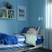 Kids bedroom with grey bed pocket on white bed with striped bedding