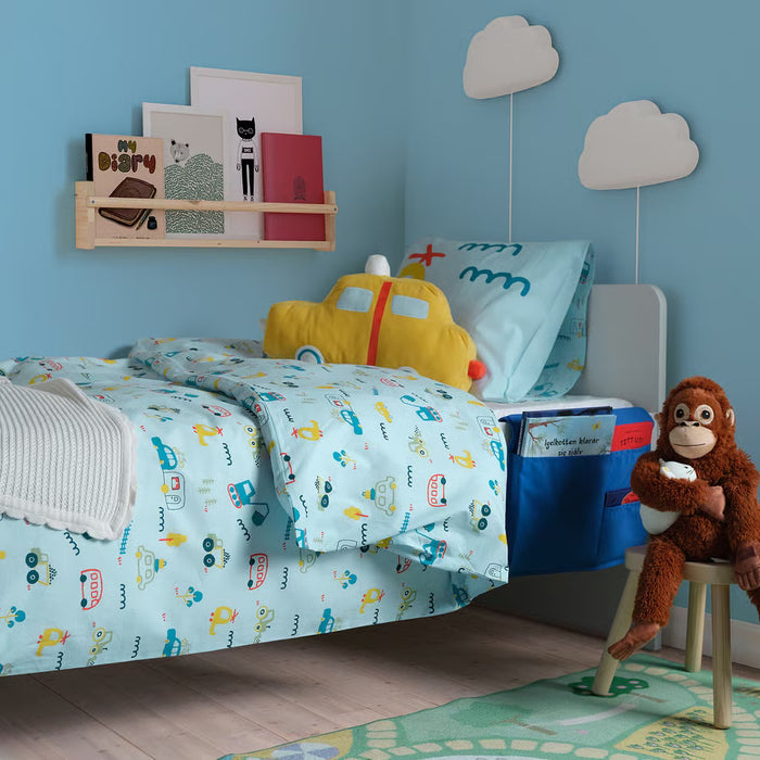 Kids bedroom with blue bed pocket holding books and toys bedside