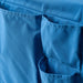 IKEA STICKAT blue bed pocket hanging on bed edge close-up view