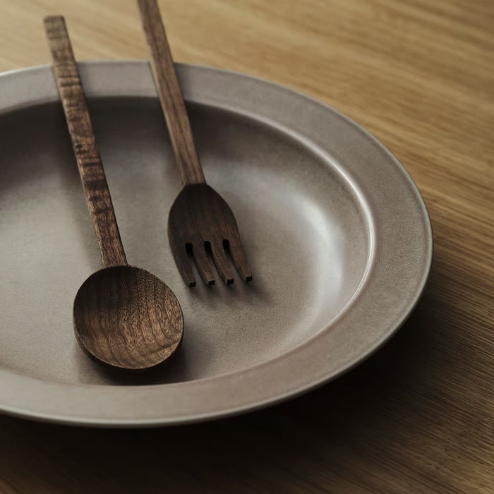 IKEA STOCKHOLM walnut salad servers resting in grey bowl