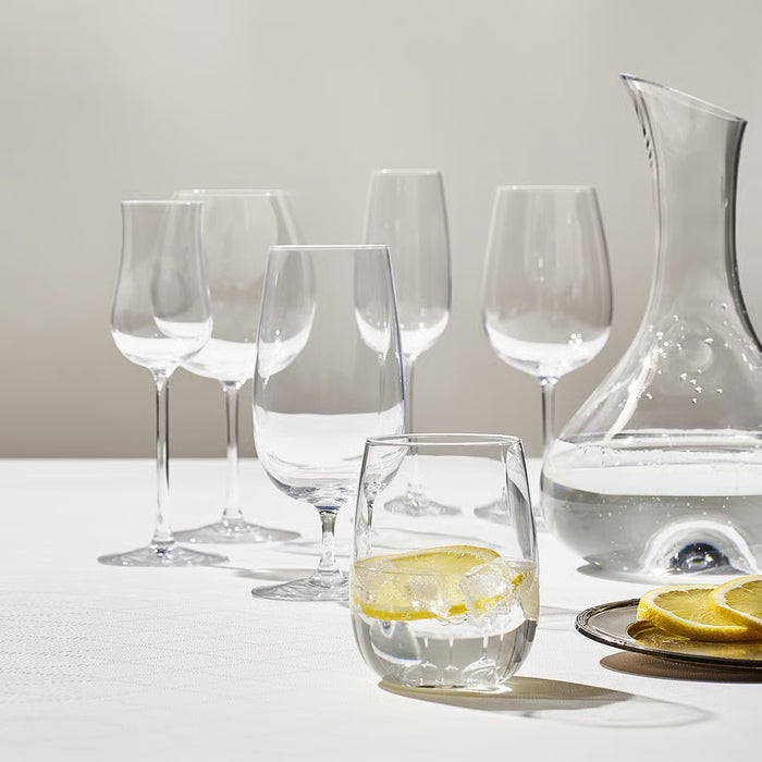 IKEA STORSINT full series of clear glasses in varying sizes arranged on a white table with lemon