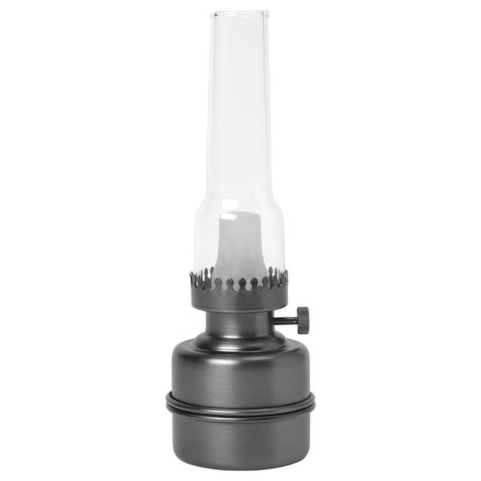 Vintage-style oil lamp with clear glass chimney on a white background