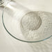 IKEA STRANDKRABBA clear glass deep plate casting hammered shadow patterns on white surface