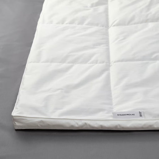 IKEA STRANDMOLKE warm duvet neatly folded on bed showing box stitching and plush lofted fill
