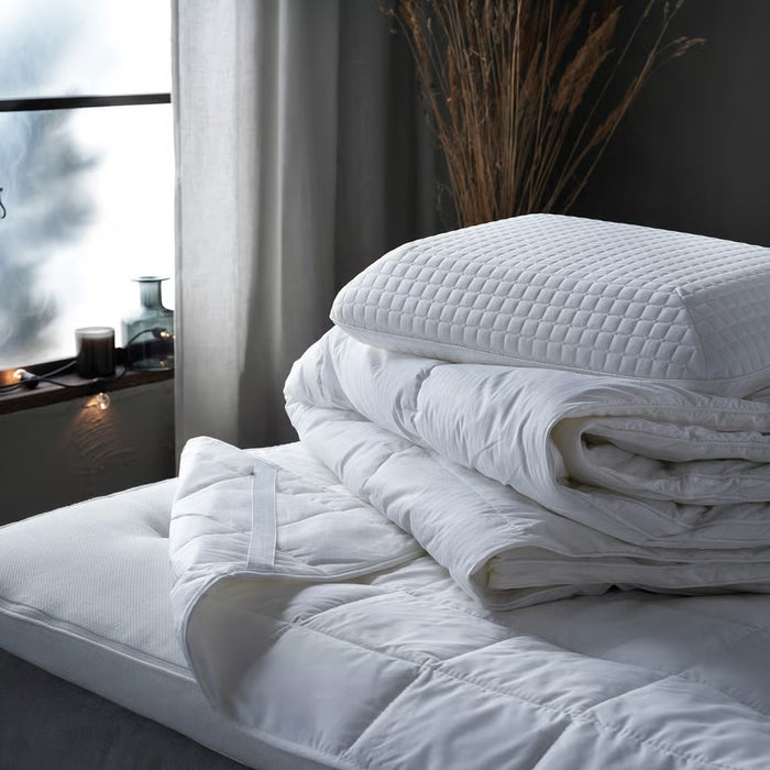  IKEA STRANDMOLKE warm duvet on a made bed with white pillows and cotton duvet cover, full room view