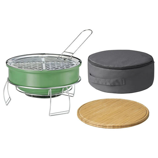 Green portable grill with gray carrying case and wooden lid on a white background