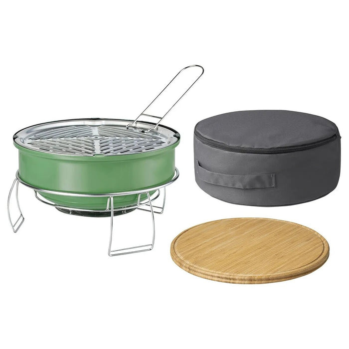 Green portable grill with gray carrying case and wooden lid on a white background