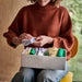 Person placing folded socks into IKEA STUK compartment box organised in a grid drawer