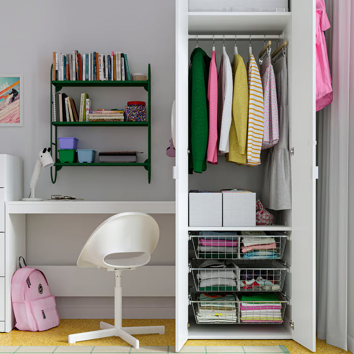 Organised bedroom setup with IKEA STUK storage boxes clothes on hangers striped bedding