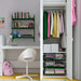 Organised bedroom setup with IKEA STUK storage boxes clothes on hangers striped bedding