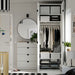 White IKEA wardrobe with STUK boxes folded clothes and mirror beside it in a modern nursery setup