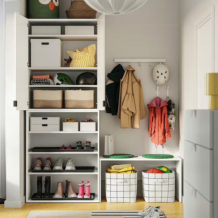 Full wardrobe shelf organised with IKEA STUK boxes storing clothes shoes and accessories neatly