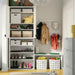 Full wardrobe shelf organised with IKEA STUK boxes storing clothes shoes and accessories neatly