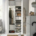 IKEA STUK white black fabric storage box placed inside open wardrobe close-up angle