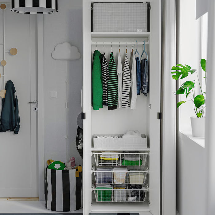 Wardrobe interior with hanging clothes, folded items and IKEA STUK storage bins