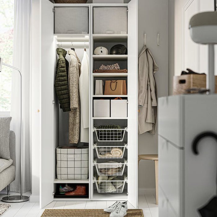 Organised closet shelves with IKEA STUK storage bins and hanging garments