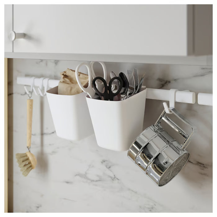 IKEA SUNNERSTA white rail with containers and hooks installed on kitchen wall with utensils